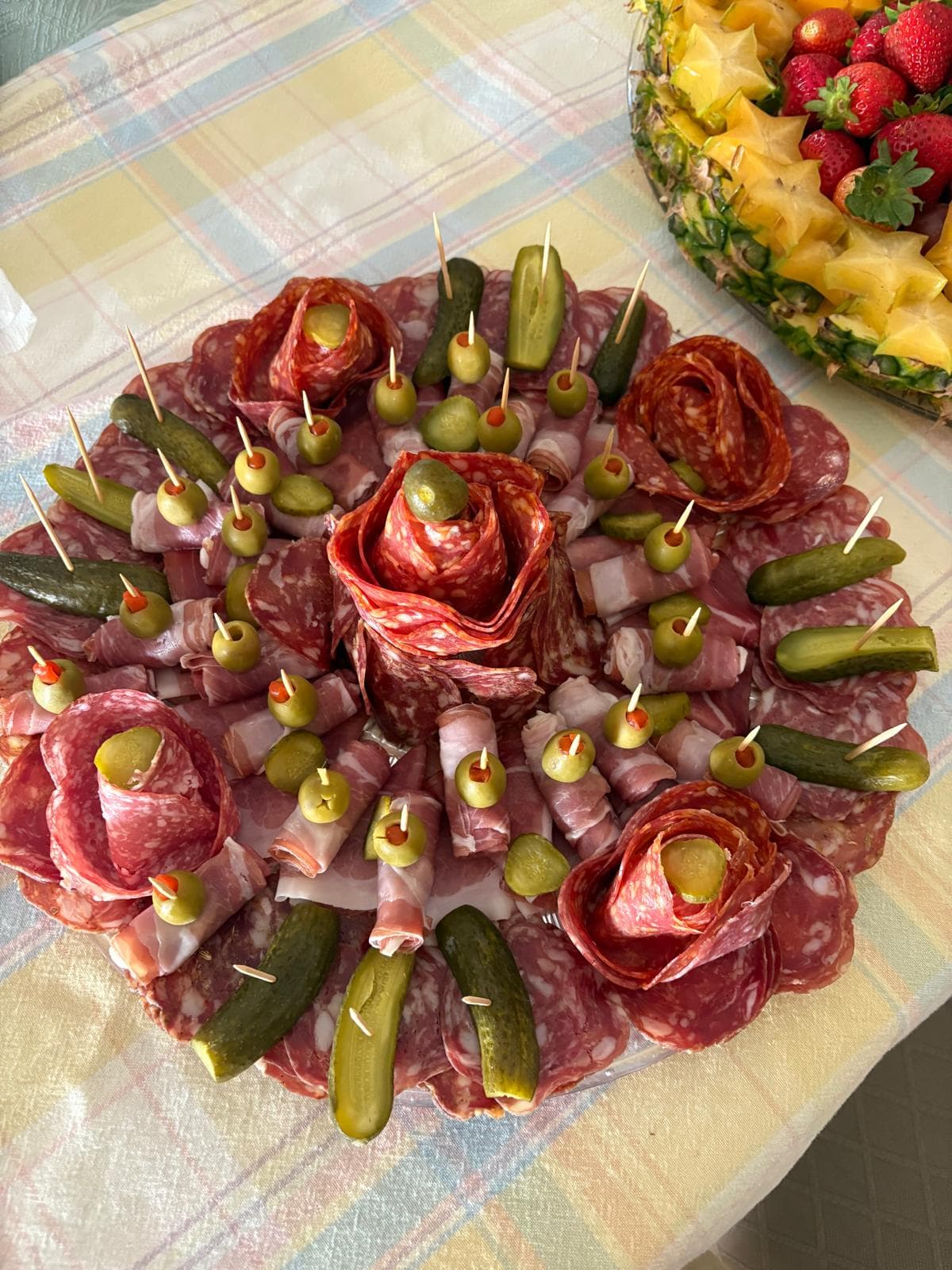 Salami rose and prosciutto platter with green olives and pickles