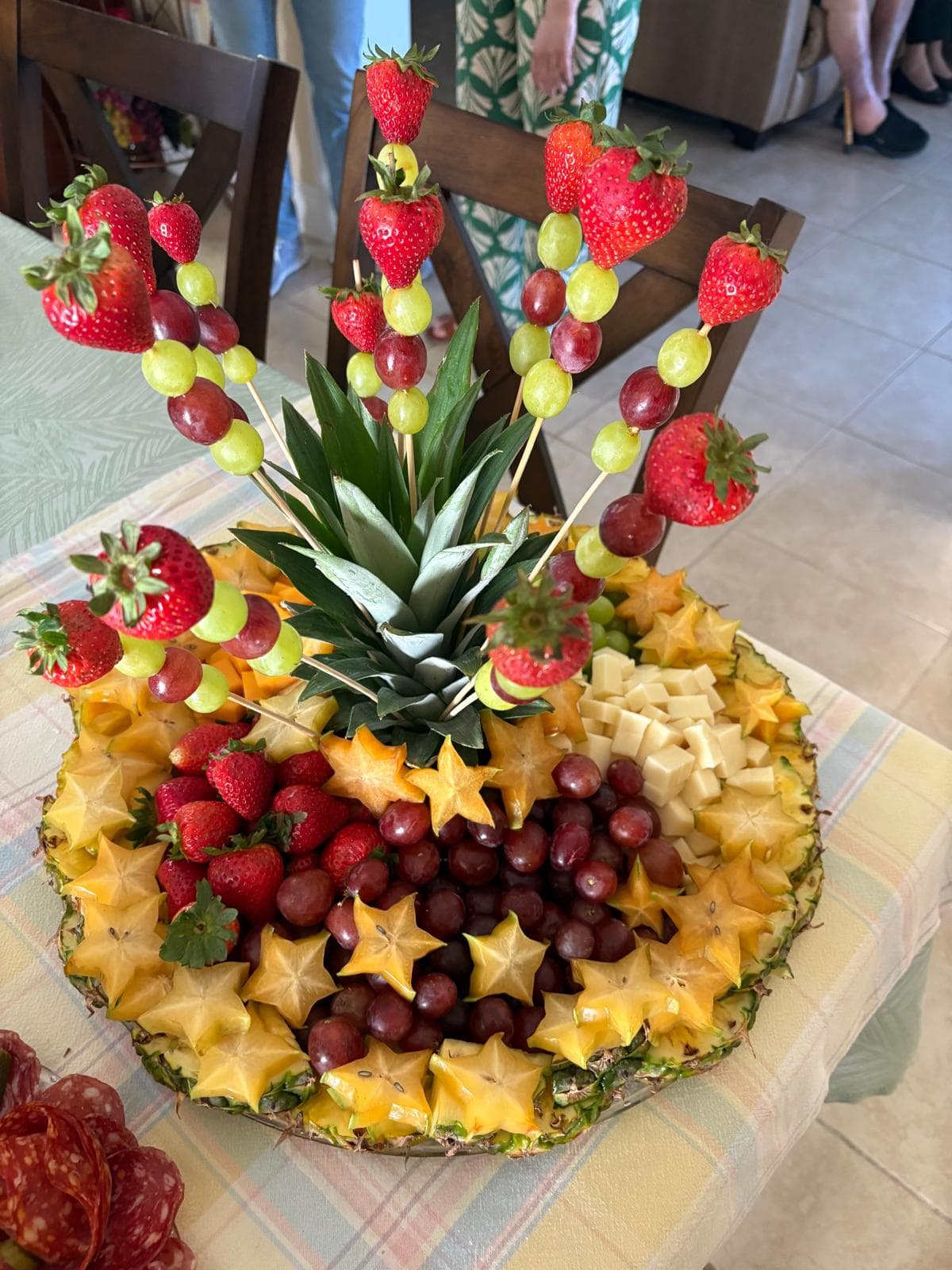 Pineapple fruit platter with strawberry and grape skewers and star fruit