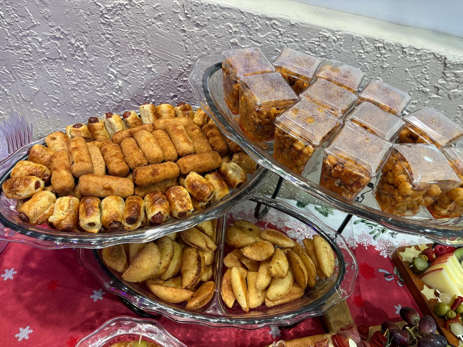Tiered stand of pastry puffs, croquettes and dessert cups