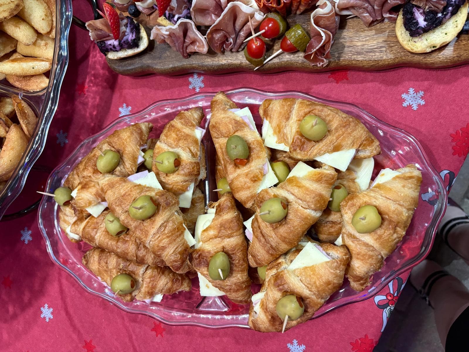 Ham and cheese croissant sandwiches topped with green olives
