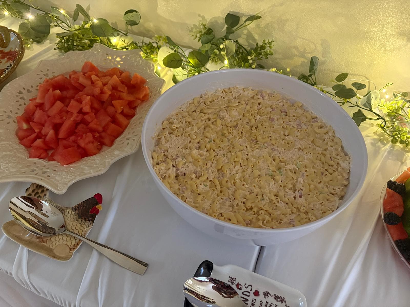 Bowl of macaroni salad beside a plate of diced watermelon